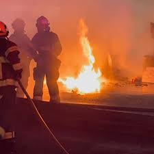 Fire crews battle car fire on W. 11th early on Thursday